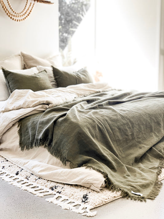RAMIE FRINGED THROW BLANKET - OLIVE / GREEN. Made from 100% ramie & hand-finished with a soft, fringed border for a relaxed look & feel. The extra-long design drapes generously over either side of your bed, creating a cozy, layered look. Available in Queen & King size.
