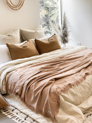 RAMIE FRINGED THROW BLANKET - BLUSH / PINK. Made from 100% ramie & hand-finished with a soft, fringed border for a relaxed look & feel. The extra-long design drapes generously over either side of your bed, creating a cozy, layered look. Available in Queen & King size.